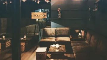 Cozy lounge with sofas and dim lighting.