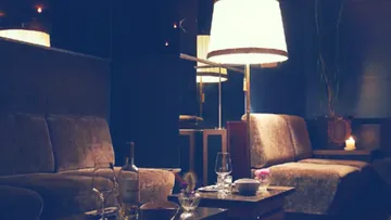 Cozy lounge with sofas and dim lighting.