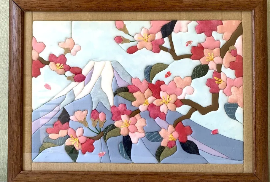 Blossoms and mountain in wooden frame art.