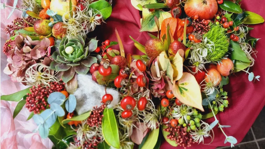 Colorful autumn wreath with leaves and berries.