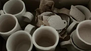 Ceramic mugs and shapes in a box.