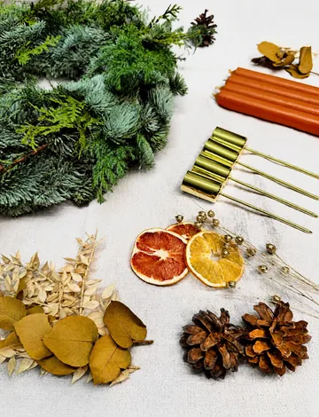 Christmas wreath and decorations on white surface.