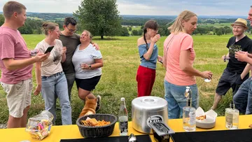 Group socializing in a grassy field.