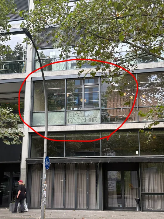 Building with large windows and tree outside.