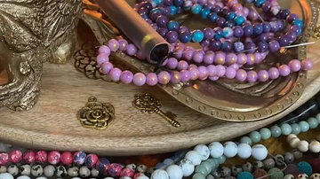 Colorful beaded necklaces on a wooden table.