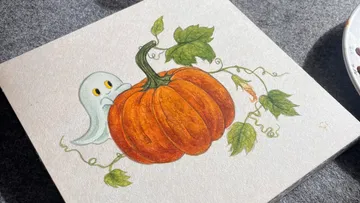 Ghost peeking around a pumpkin, leafy vine.