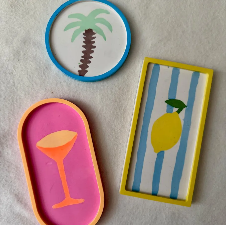 Three colorful coasters on a white surface.