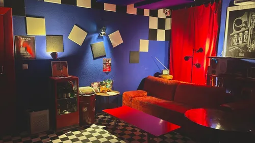 Cozy room with red couch and decor.
