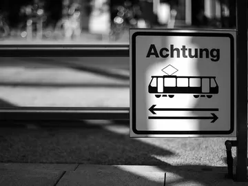 Warning sign warns of passing trams in urban areas.