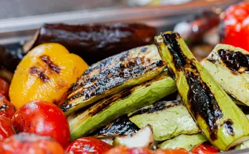 Grilled vegetables including zucchini, peppers, and tomatoes.