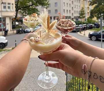 Hände halten Cocktails im Freien auf Straße.