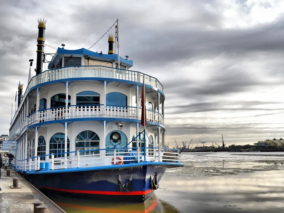 A steamer is lying on the shore, surrounded by grey skies.