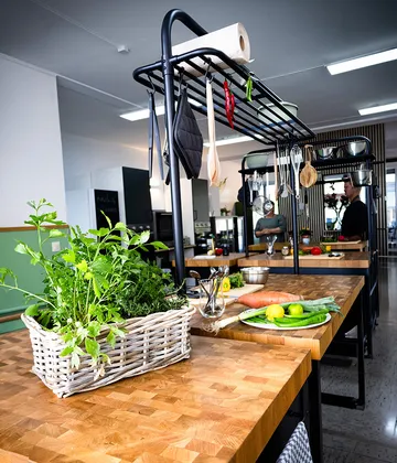 Kitchen cooking area with herbs and utensils.