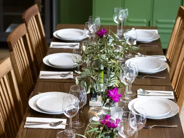 Table set with plates and flowers, indoors.
