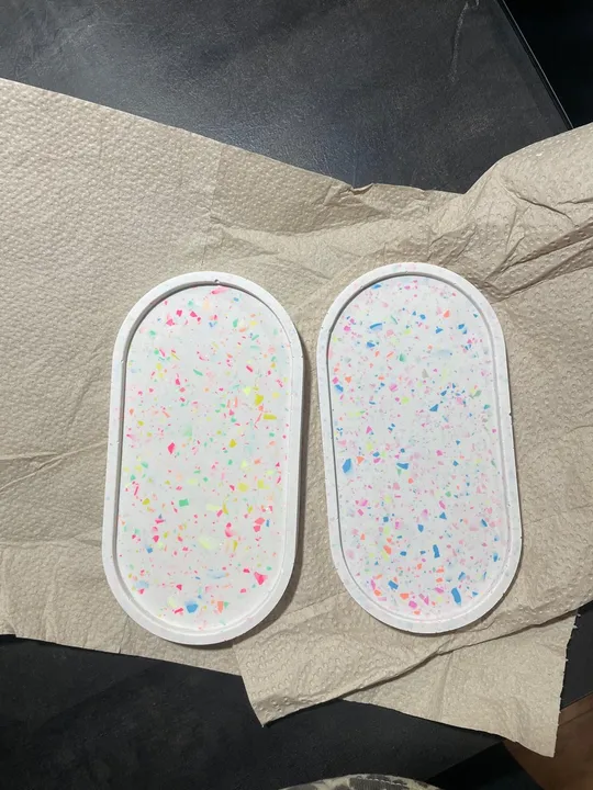 Colorful oval coasters on paper towel.