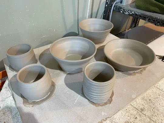 Clay bowls arranged on a workshop table.