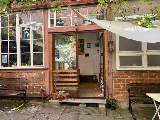 Open door to cozy brick courtyard.