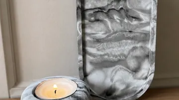 Marble candle holder on wooden surface.