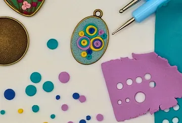 Polymer clay crafting tools on white workspace.