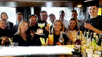 Group toasting drinks in a bar.