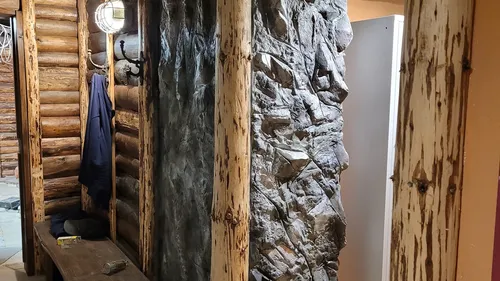 Wooden room with coat hung on wall.