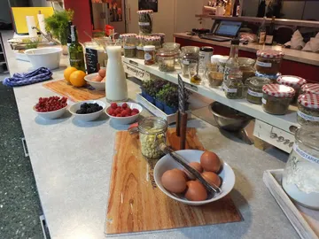 Kitchenette equipped with ingredients and utensils for cooking.