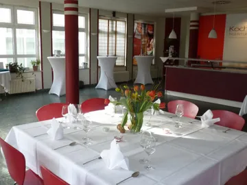 A set table in a bright restaurant room.