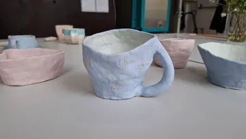 Ceramic mugs on a light surface.
