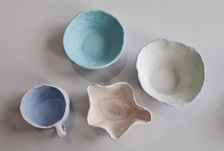 Ceramic mugs and bowls on a table.