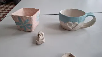Clay cup and bowl with heart designs.