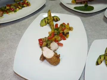 Grilled chicken fillet with colorful vegetables on plate.