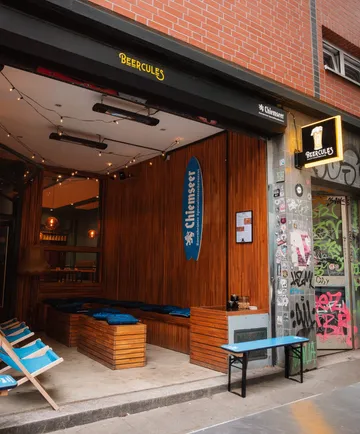 Outdoor seating area, bar entrance, graffiti wall.