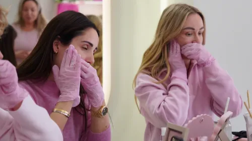 Women applying skincare in a salon.