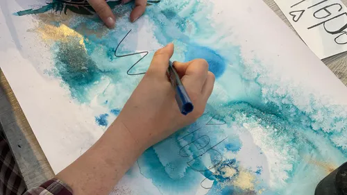 Hand writing on abstract watercolor painting.