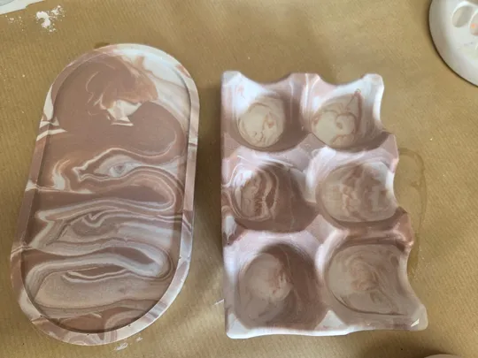 Marble trays on a wooden surface.