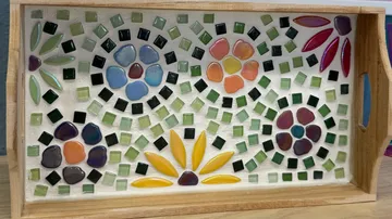 Mosaic tray with colorful floral patterns.