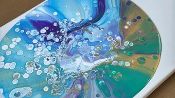 Colorful acrylic paint swirl with bubbles.