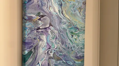 Abstract painting with swirling colors on canvas.