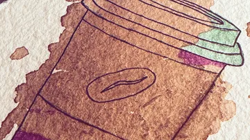 Coffee cup drawn with watercolor stains.