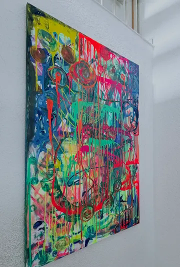 Colorful abstract painting on white wall.