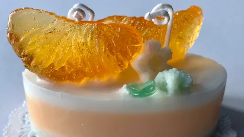 Small cake with colorful, fruity decoration on top.