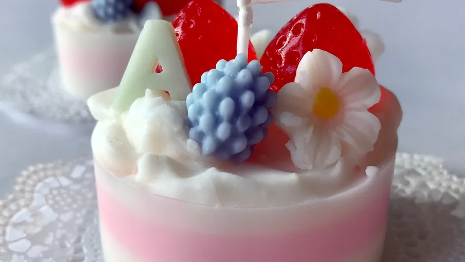 Colourful dessert cake with fruit and decorative icing.