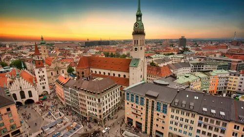 Stadtplatz mit historischen Gebäuden bei Sonnenuntergang.