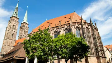 Gothic church with pointed towers, blue sky.
