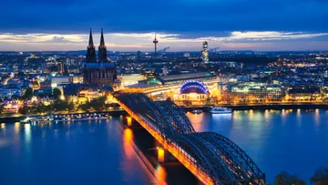 Bridge and illuminated cityscape at dusk