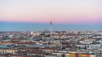 Cityscape with tower during sunset twilight.