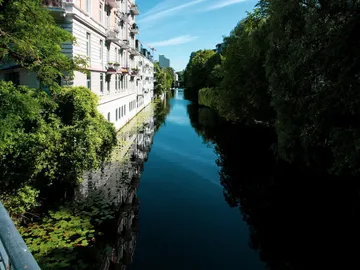 A quiet channel reflects trees and buildings.