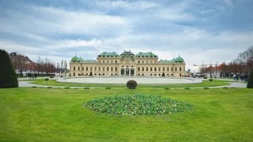 Palace with garden in front, overcast day.