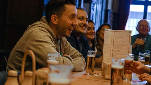 Group of people laughing in a bar.