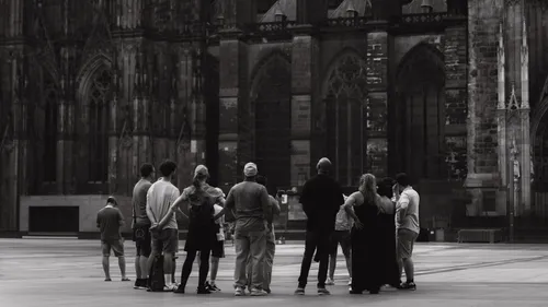 Group of people gathered outside a cathedral.
